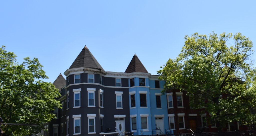 RowHouses are framed by trees.